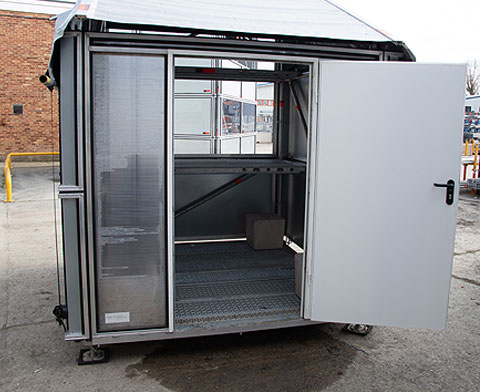 2m x 2m ground-level Control structure clad with Layher Protect wall cassettes, acrylic front windows and lockable rear door.
